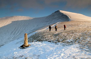 Climbing a snow covered Pen-y-Fan in gold evening light